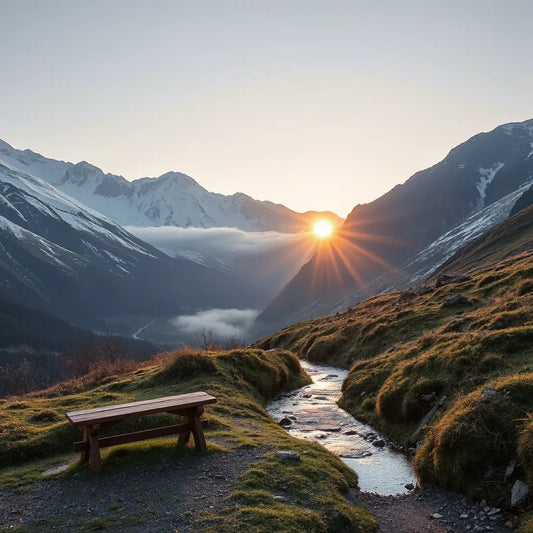 Snowy Swiss Alps peaks at sunrise with an alpine stream and quiet bench in the foreground